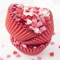 Heart shaped sprinkles in baking cups. Royalty Free Stock Photo