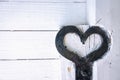 A heart shaped in steel on a white cabin door