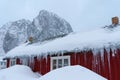 Heart shaped stone mountain behind the famous tourist attraction Hamnoy fishing village on Lofoten Islands, Norway with red rorbu Royalty Free Stock Photo