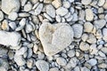 A heart-shaped stone on a pebble beach in France Royalty Free Stock Photo