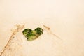 Heart-shaped stone on a sandy beach Royalty Free Stock Photo