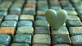 A heart shaped stone sitting on top of a bunch of other stones, AI Royalty Free Stock Photo