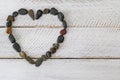 Heart shaped stone, small pebbles arranged as a heart on white w Royalty Free Stock Photo