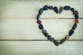 Heart shaped stone, small pebbles arranged as a heart on white w Royalty Free Stock Photo