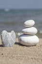 Heart shaped stone and stack of pebbles on balance on sand Royalty Free Stock Photo