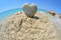 Heart shaped stone on white rock Royalty Free Stock Photo