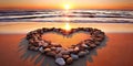 Heart-shaped stones on a sandy beach, illuminated by the warm colors of a sunset Royalty Free Stock Photo