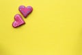 Heart shaped sugar cookie on yellow background. Valentines day card concept.