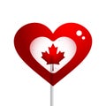 Heart shaped sweet lollipop and maple leaf, Canada symbol on a white background Royalty Free Stock Photo