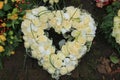 Heart shaped sympathy wreath near a tree Royalty Free Stock Photo