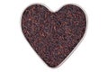 Heart shaped tin pan full of raw Riceberry rice grains in reddish purple isolated on white
