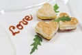 Heart shaped toasts sandwiches with ham and cheese on a plate. Homemade Healthy food Royalty Free Stock Photo