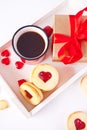 Heart shaped traditional linzer cookies with strawberry jam, mug of coffee and gift box. Valentine s day concept. Royalty Free Stock Photo
