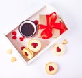 Heart shaped traditional linzer cookies with strawberry jam, mug of coffee and gift box. Valentine s day concept. Royalty Free Stock Photo