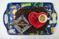 Heart shaped tray with coffee beans, cup and saucer