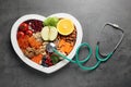 Heart shaped tray with healthy products and stethoscope Royalty Free Stock Photo