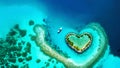 heart shaped tropical island reef with boat, aerial view symbolizing love, with empty negative space