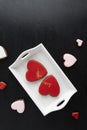 Heart-shaped Valentines Day cookies with icing sugar on white plate. Vertical frame Royalty Free Stock Photo