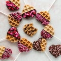 Heart shaped waffle pops forming a circle and one in the middle with a bite out.