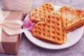 Heart Shaped Waffles for Breakfast with Gift Box on table with Little Pink flower, View from above Royalty Free Stock Photo