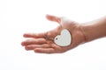 Heart shaped white object in hand on white