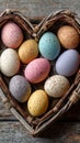 Rustic wooden table sets against pastel Easter eggs and a heart-shaped wicker basket on a clean background with plenty of space Royalty Free Stock Photo