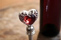 Heart-shaped wine bottle stopper with crystal detailing. AI Generated Royalty Free Stock Photo