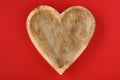 Heart shaped wooden bowl on a red background, rustic happy ValentineÃ¢â¬â¢s Day
