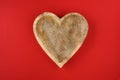 Heart shaped wooden bowl on a red background, rustic happy ValentineÃ¢â¬â¢s Day