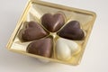 Heart shapped chocolate sweets, brown and white color, transparent plastic box with pralines