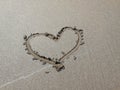 A heart sign painted on the sand of the beach. Concept of love, vacation, romance Royalty Free Stock Photo