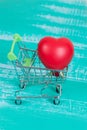 heart sign in shopping cart on color wood Royalty Free Stock Photo