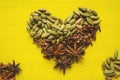 Heart sign from spices over yellow