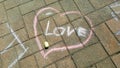 Heart sketch with the text love - chalk drawing on stone pavement Royalty Free Stock Photo