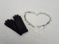 heart in the snow and black gloves Royalty Free Stock Photo