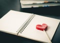 Heart stick on blank notebook on desk Royalty Free Stock Photo