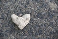 Heart of stone. Concept of toughness, no heart and no love. Heart-shaped marine stone. Fiend. cold blooded, disheartened