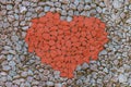 Heart stone red contrast on a gray background symbol of love set of stones painted stones set background base Royalty Free Stock Photo