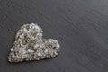 Heart of stones, love. Scattered diamonds on black background. Raw diamonds and mining, a scattering of natural diamond stones. Royalty Free Stock Photo