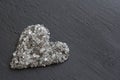 Heart of stones, love. Scattered diamonds on black background. Raw diamonds and mining, a scattering of natural diamond stones. Royalty Free Stock Photo