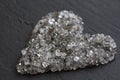 Heart of stones, love. Scattered diamonds on black background. Raw diamonds and mining, a scattering of natural diamond stones. Royalty Free Stock Photo