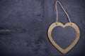 Heart on a string on natural dark wood. Frame heart handmade hanging on the dark wooden Board. Valentines day greeting card. Heart Royalty Free Stock Photo