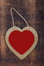 Heart on a string on natural dark wood. Frame heart handmade hanging on the dark wooden Board. Valentines day greeting card. Heart Royalty Free Stock Photo