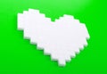 Heart of sugar cubes, green background