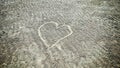 A heart symbol drawn on the beach sand. Royalty Free Stock Photo