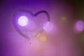 heart symbol hand drawn on wet night window glass in pink colors Royalty Free Stock Photo