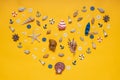 Heart symbol made of decorative items, miniature toys: seashells, seastar, boat, vessel, anchors, steering wheels, life buoys.