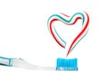 the heart symbol is made from a three-color toothpaste and is located above the toothbrush Royalty Free Stock Photo