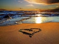 Heart symbol on sunset beach sand and sea water reflection light nature landscape romantic summer background Description