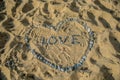 Heart Symbol And Word Love On Sand